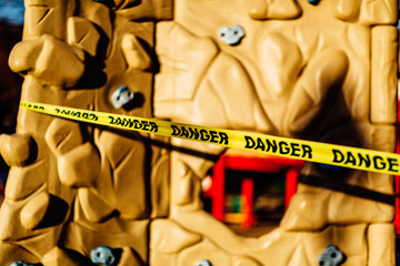 The playground during quarantine is sealed with warning signs, a tape with the word Danger. Coronavirus, Covid-19