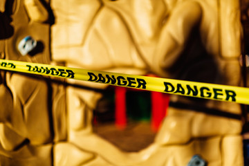 The playground during quarantine is sealed with warning signs, a tape with the word Danger. Coronavirus, Covid-19