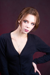 Fototapeta na wymiar Beautiful girl model in a black blouse. Studio portrait.