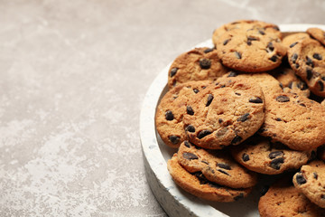 Tray with chocolate chip cookies brown table