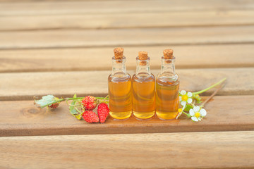 Essence of Wild strawberry on table in beautiful glass jar