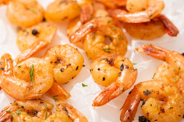close up view of fried shrimps on white parchment paper