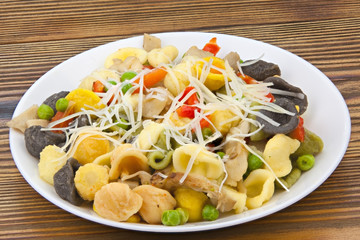 tasty appetizing pasta with vegetables on white plate