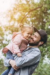 Happy Smiling Young Dad Playing With His Kid. Family Relationships Concept