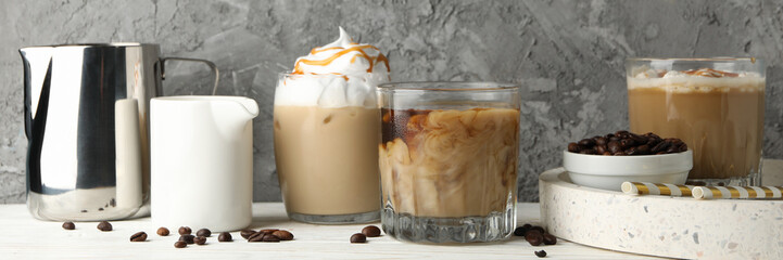 Composition with ice coffee on white wooden background
