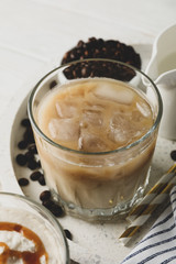Composition with tray with ice coffee on wooden background