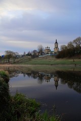 Fototapeta na wymiar Landscape with church and river in early morning