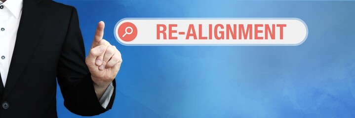 Re-alignment. Lawyer in suit points with his finger to a search box. The term Re-alignment is in...