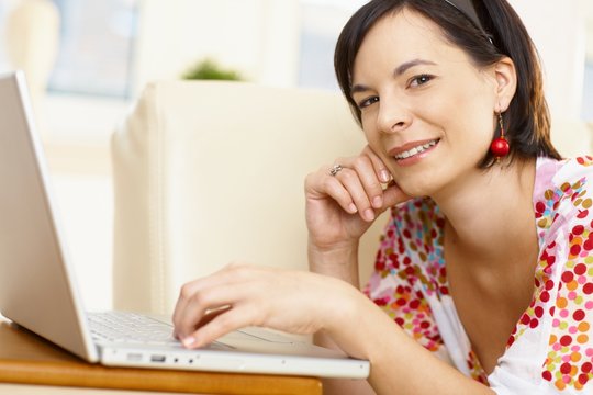 Young caucasian woman using computer at home, copy space.