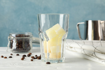 Composition with ice coffee on white wooden background