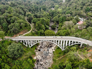 Arial view Arc bridge over the mountain river