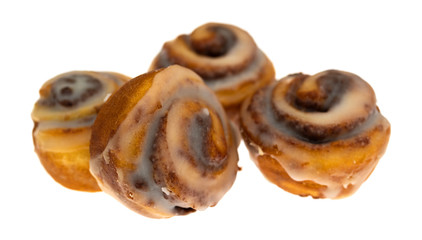 Fototapeta premium Four bite size cinnamon swirl rolls on a white background