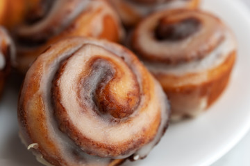 Bite size cinnamon swirl rolls on a white plate