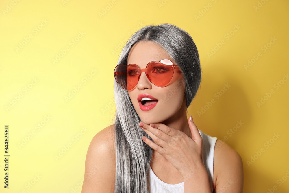 Canvas Prints Portrait of young woman with beautiful grey colored hair on yellow background