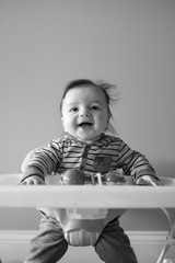 Baby boy smiling in a walker