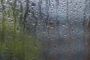 Rain drops on window glass surfaces