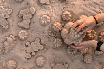 child plays in the sand on the beach