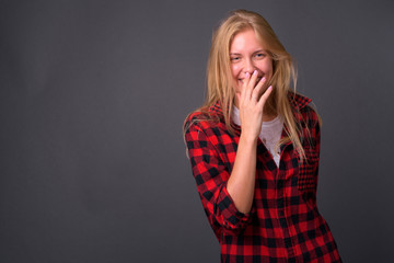 Portrait of happy young hipster woman with blond hair laughing