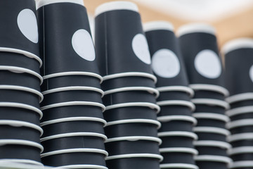 stacks with disposable paper cups for coffee