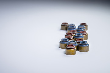 Set of new oil seals for suction and exhaust valves on a gray gradient background.