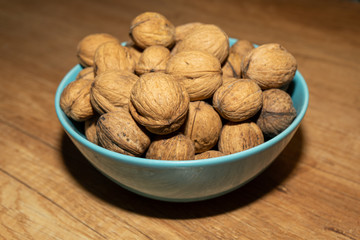 Inshell walnuts in a bowl. A full bowl of walnuts.