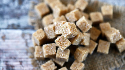 Selective focus. Macro. Cubes of brown sugar. Demerara sugar.