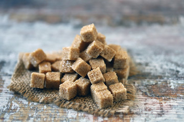 Selective focus. Macro. Cubes of brown sugar. Demerara sugar.
