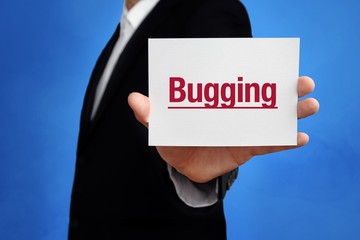 Bugging. Lawyer in a suit holds card at the camera. The term Bugging is in the sign. Concept for law, justice, judgement