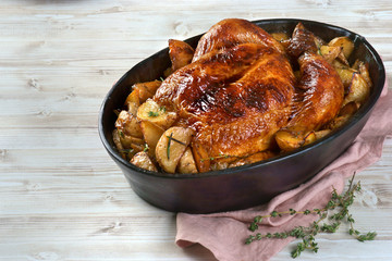 Family dinner. Baked chicken with potatoes