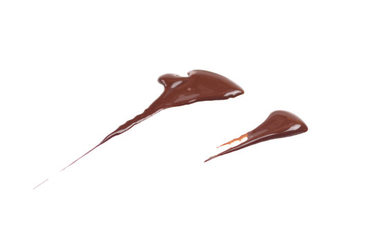 Liquid chocolate drop smeared on the surface. Chocolate sauce, ganache. Photo isolated on a white background.