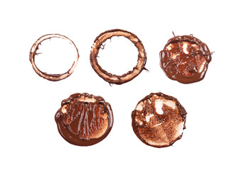 Set of chocolate stamp in circle and ring shapes. Dessert presentation. Round shape chocolate sauce, ganache, gravy. Top view photo isolated on a white background.