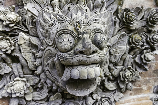 Close-up Barong head sculpted in stone to decorate a temple wall. Sonobudoyo Museum at Yogyakarta city, Island of Java