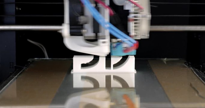 3D printed text time lapse, image sequence. Close-up of a 3d printer machine printing a PLA white plastic piece over black background