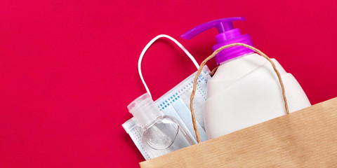 Paper bag with plastic bottles, liquid soap and gel sanitizer as