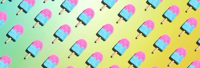 Pink and blue popsicles with shadow - overhead view