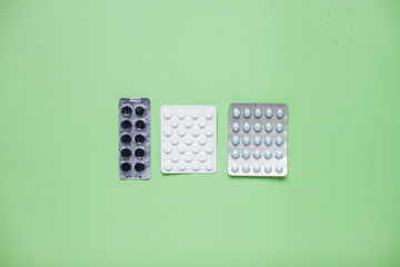 Blisters with pills. Medicine. Layout. Green background
