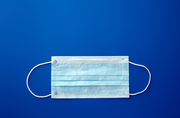 Medical mask, Medical protective mask on blue background. Disposable surgical face mask cover the...