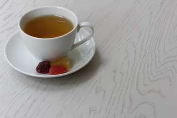 A Cup of tea and slices of marmalade on a saucer