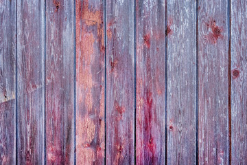 Purple and red texture of an old wooden fence with abstract pattern, table board background	