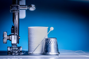 Tools for tailor, instruments for practicing sewing on a blue background.