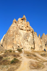 Fototapeta na wymiar Rock formations and cave city in Cappadocia Turkey. Tuff volcanic cliffs and sandstone hills landscape.
