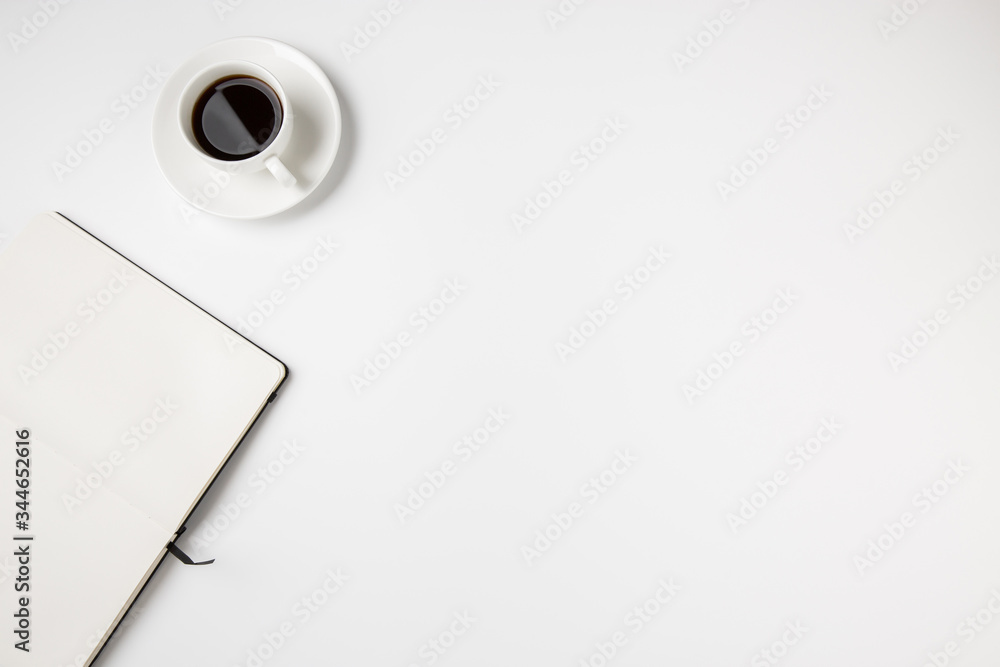 Poster abstract minimal white desk top with coffee cup and empty open notebook page