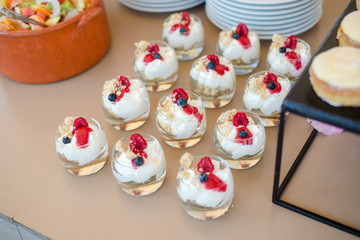 The catering wedding buffet for events. Wedding reception dessert table with delicious decorated...