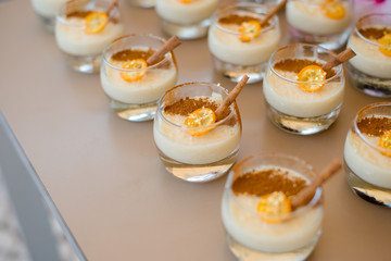 The catering wedding buffet. Wedding reception dessert table with delicious decorated white cupcakes with berries closeup.