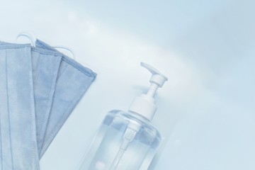 medical mask and hand sanitizer bottle with white background
