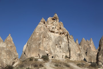 Rock formations and cave city  in Cappadocia Turkey. Tuff volcanic cliffs and sandstone hills landscape.