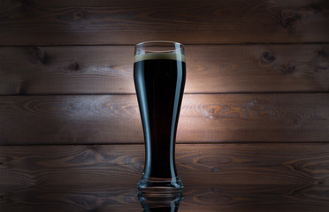 Dark Beer in Glass over Wooden Background. Isolated Mug Full of Fresh Beer