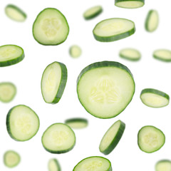 Cucumber Slices Flying in Air on White Background. Set of Close Up Sliced Cucumber