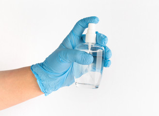 Hand holding an antibacterial spray with blue medical glove. Protection against Coronavirus (Covid-19). Hygienic concept. Isolated white background. .