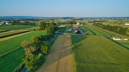 Fototapeta na wymiar Aerial view of farm lands and corn crop with a train right of way in late afternoon